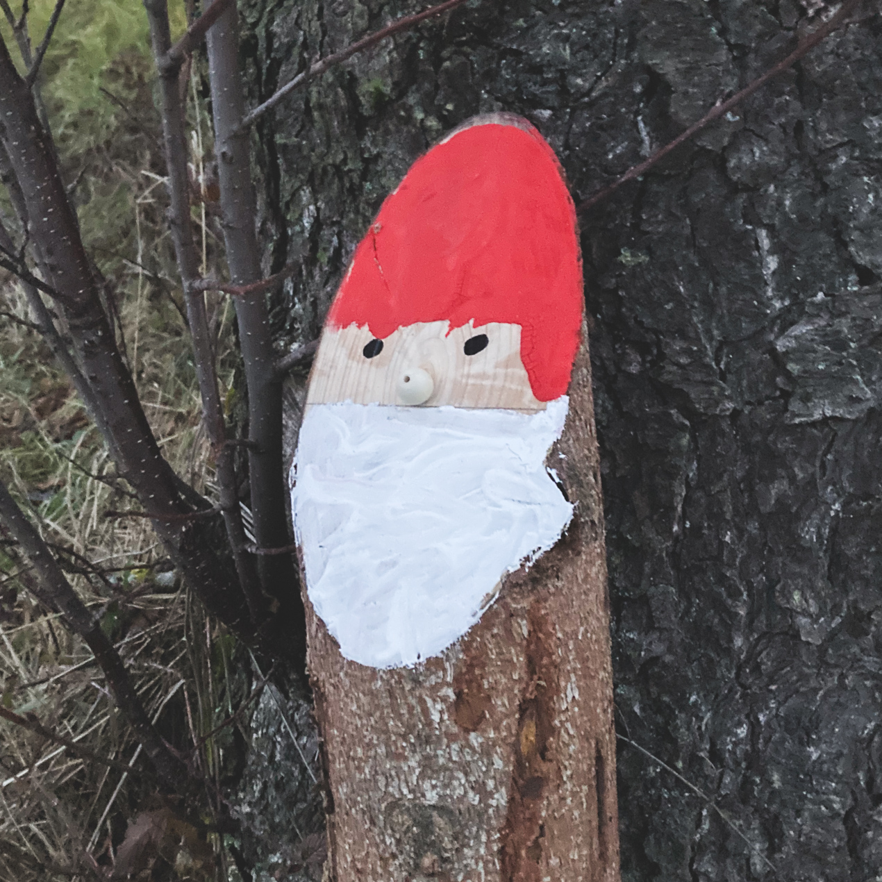 Ein Baumstamm, der wie ein Weihnachtsmann bemalt ist